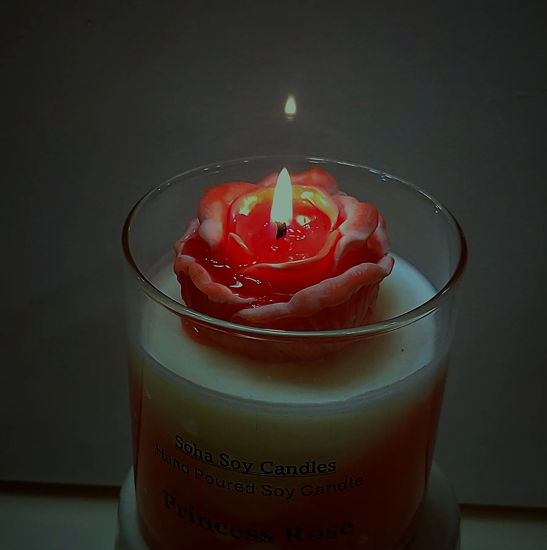 Princess Rose candle glowing by candlelight