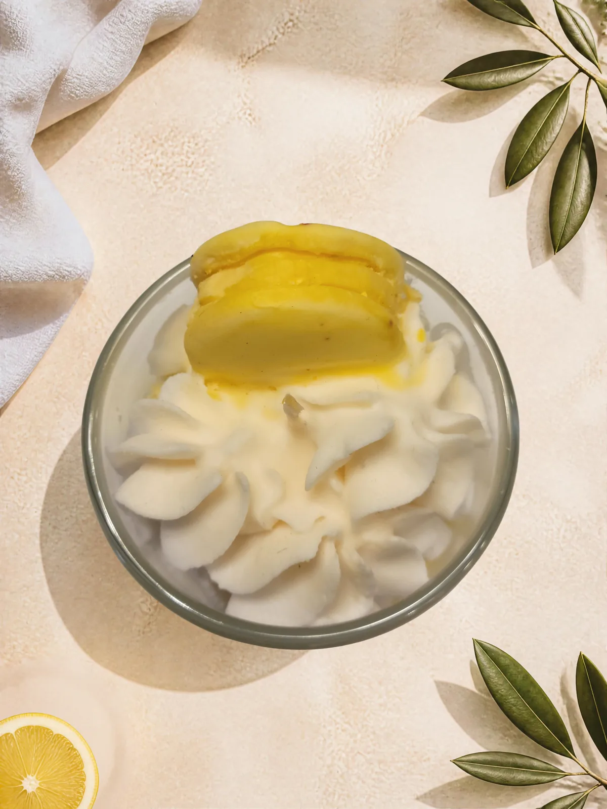 Top view of Lemon Macaron Creme candle with piped wax and macaron-style topper