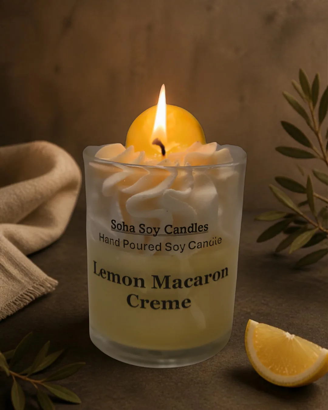 Burning Lemon Macaron Creme candle in a dark warm lifestyle setting
