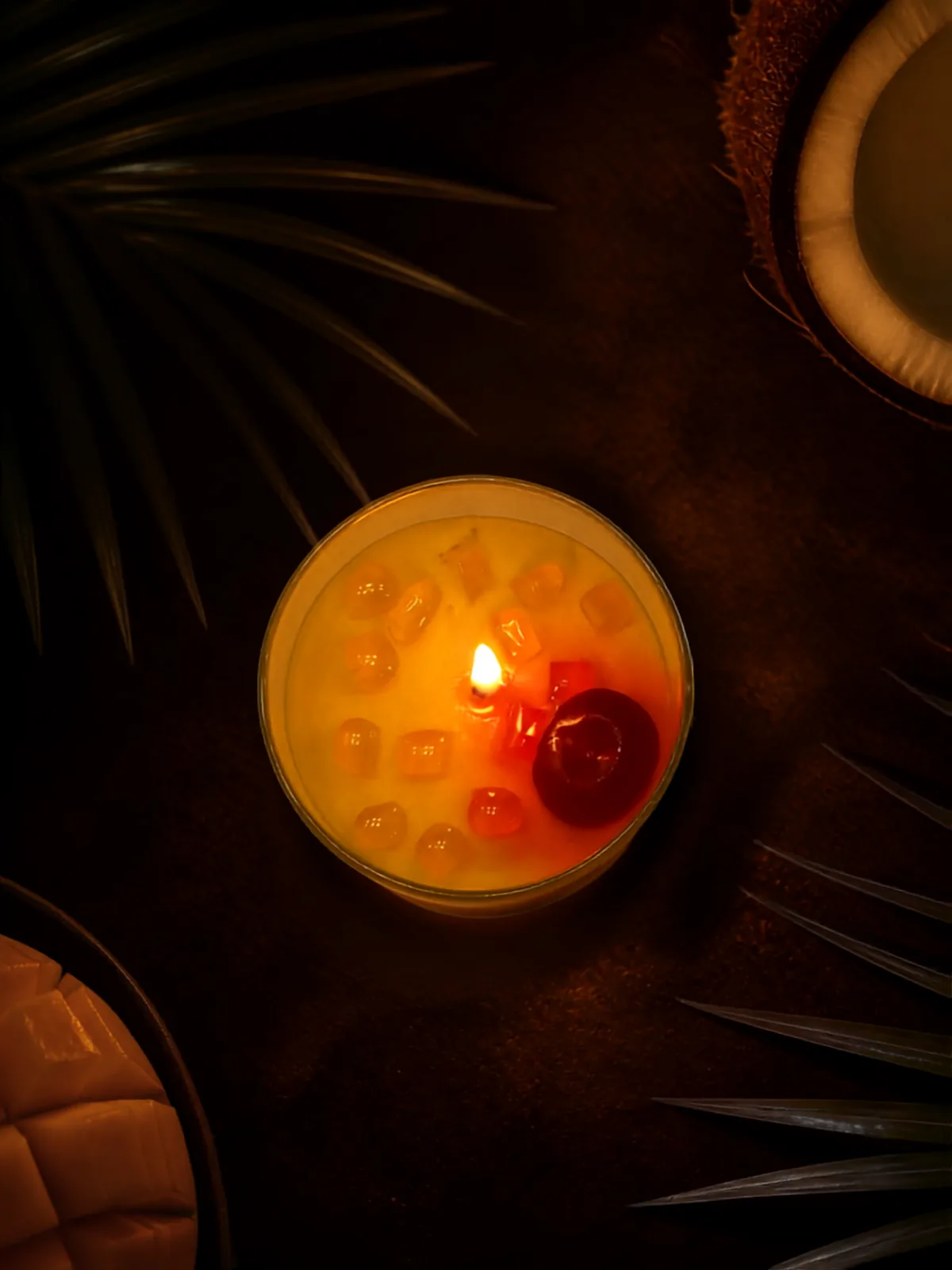 Dark top view of a burning Mango Coconut Slush candle