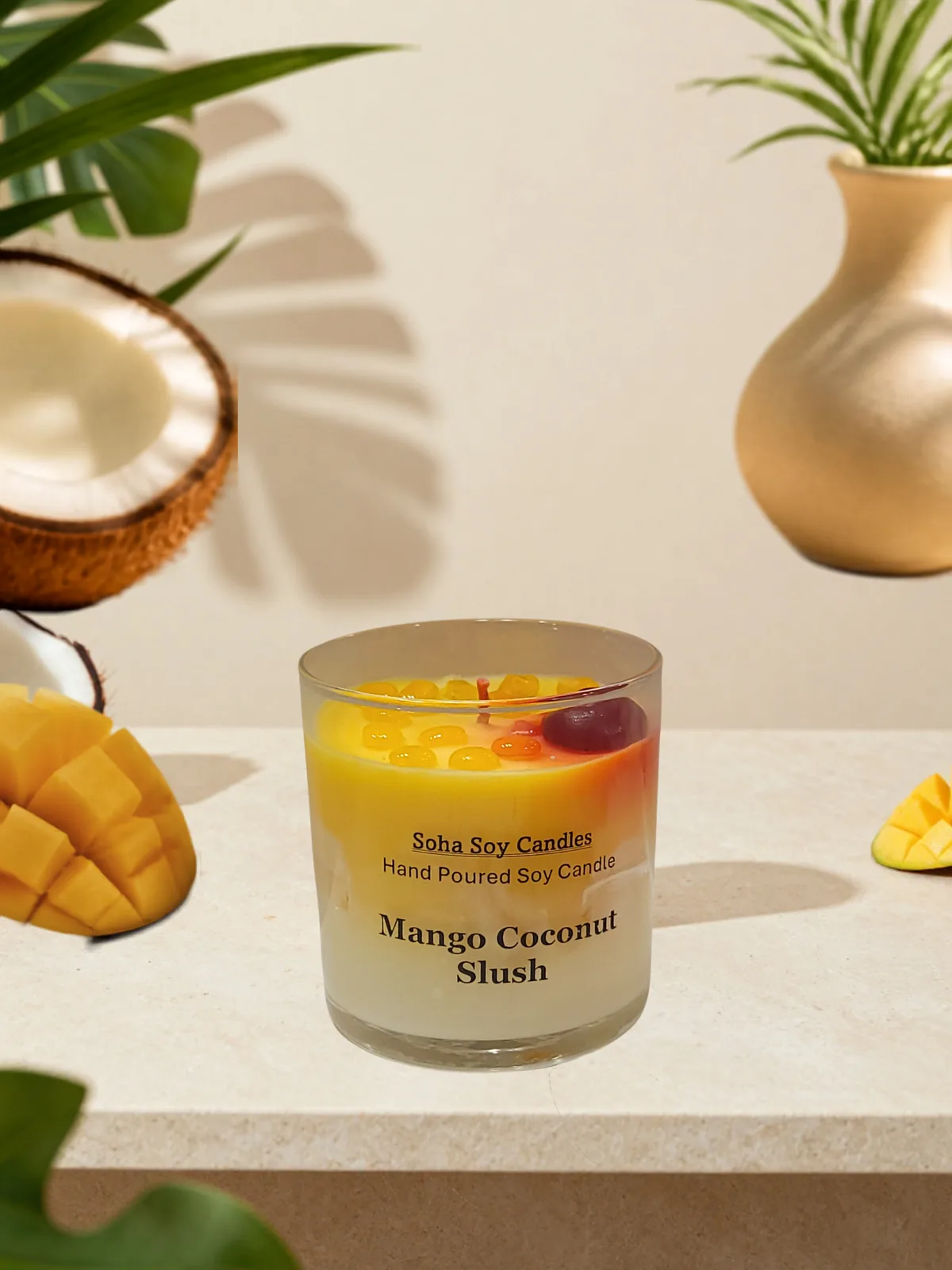Mango Coconut Slush candle styled with mango, coconut and tropical greenery
