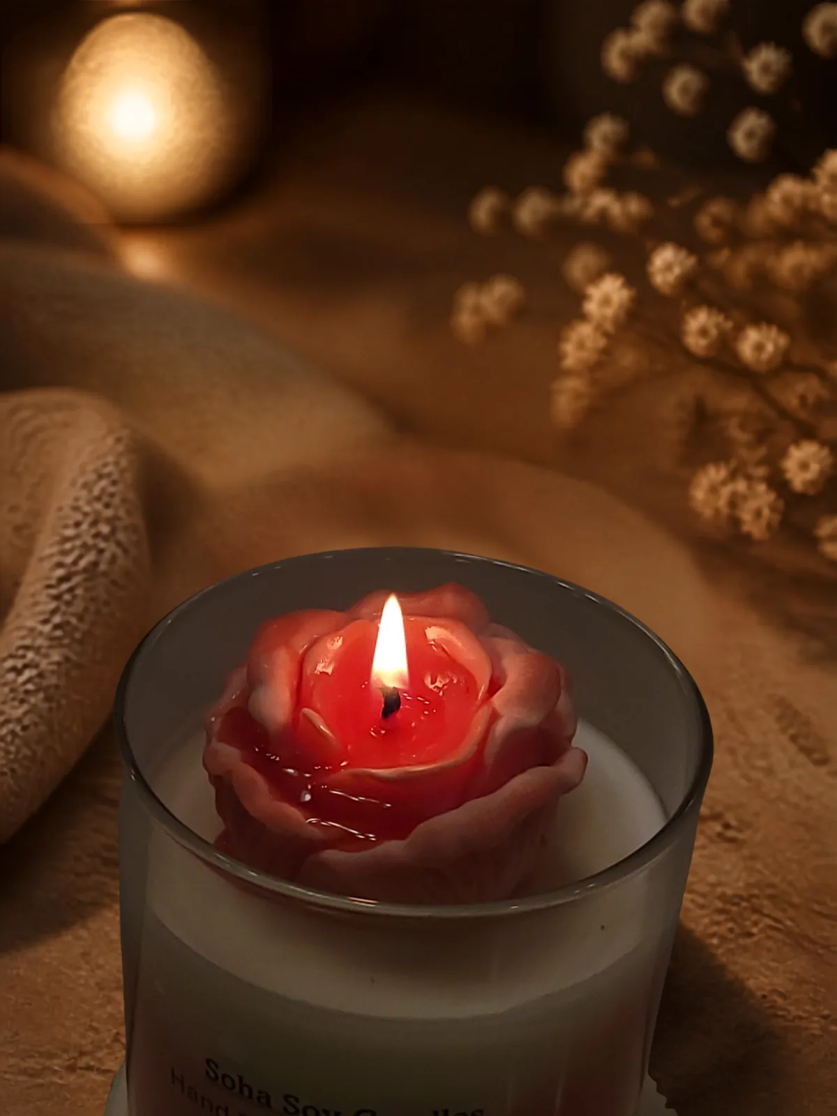Close-up of the burning sculpted rose wax topper on Princess Rose