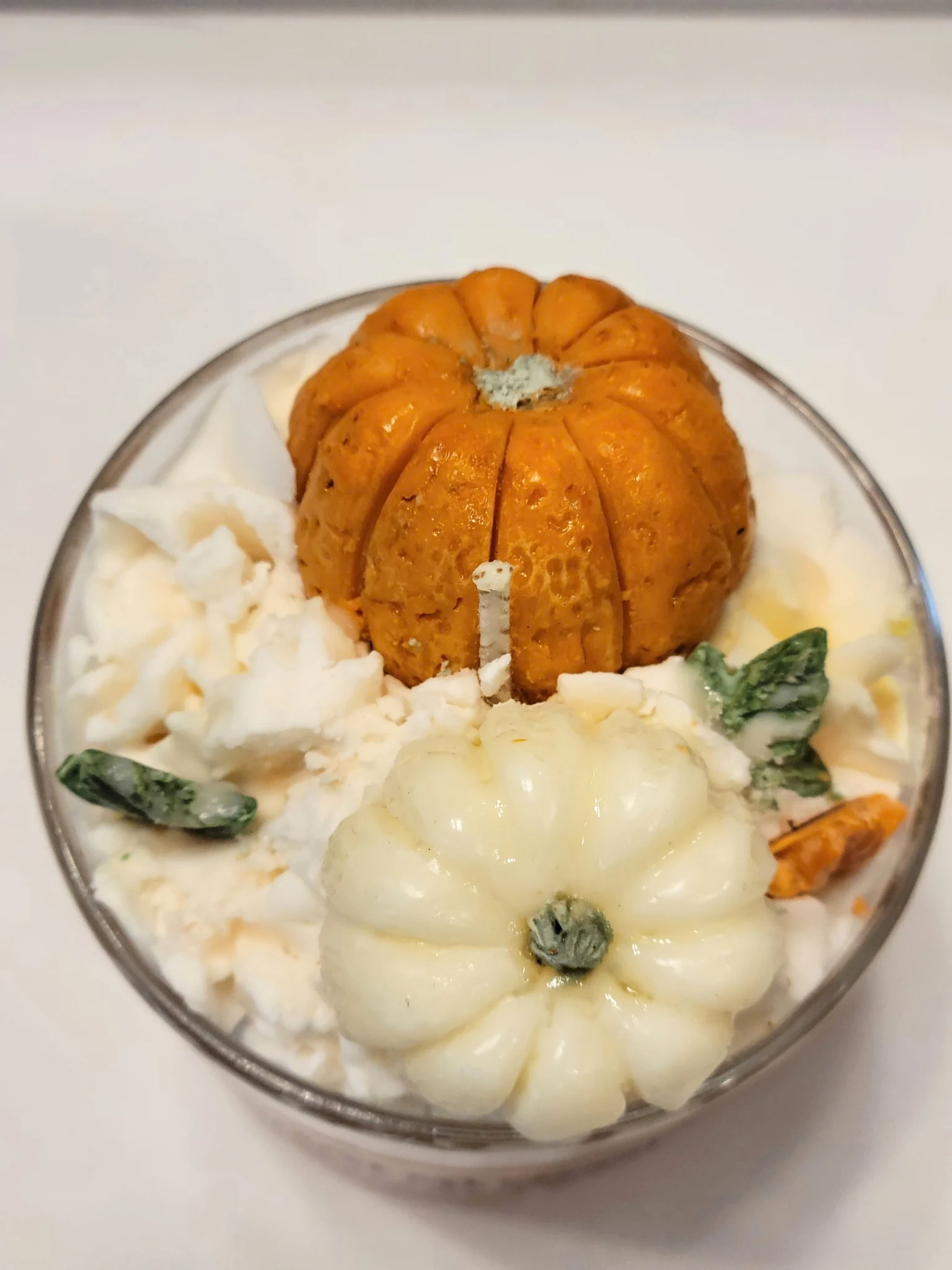 Overhead view of Pumpkin Spice candle with two decorative pumpkin wax toppers