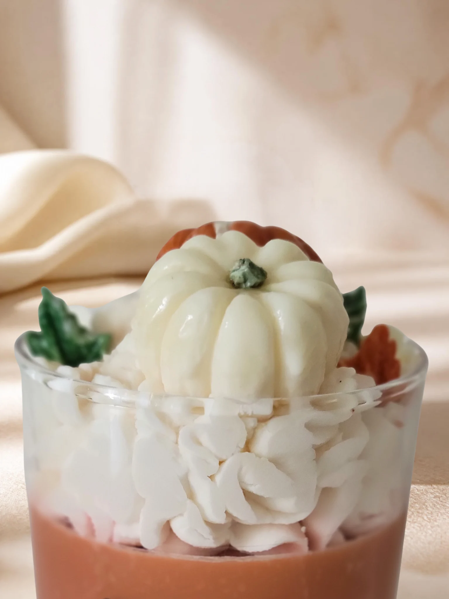 Close-up of white pumpkin wax topper and whipped wax details