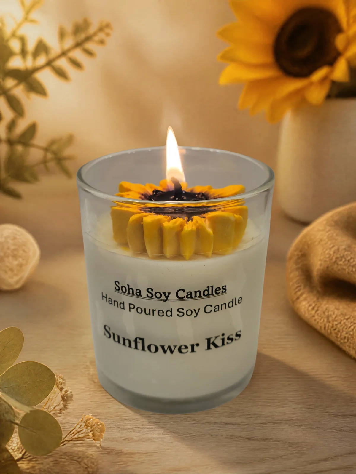 Burning Sunflower Kiss candle with glowing sunflower wax petals